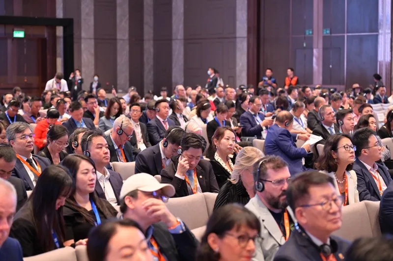 Delegates wearing headsets in the plenary hall at the Global Tourism Economy Forum